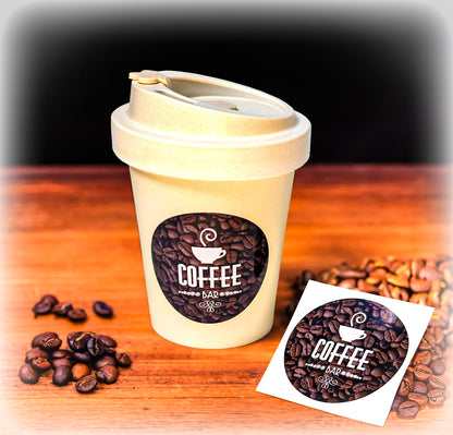 Personalised coffee company branded stickers, placed on to a coffee cup. Product image for Kraken Signs.